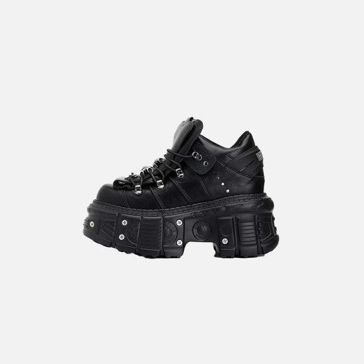 Side view of the black Heart-Tongue Platform Sneakers in a gray background