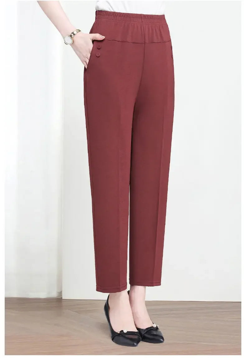 Maroon pants worn by a person on a white background