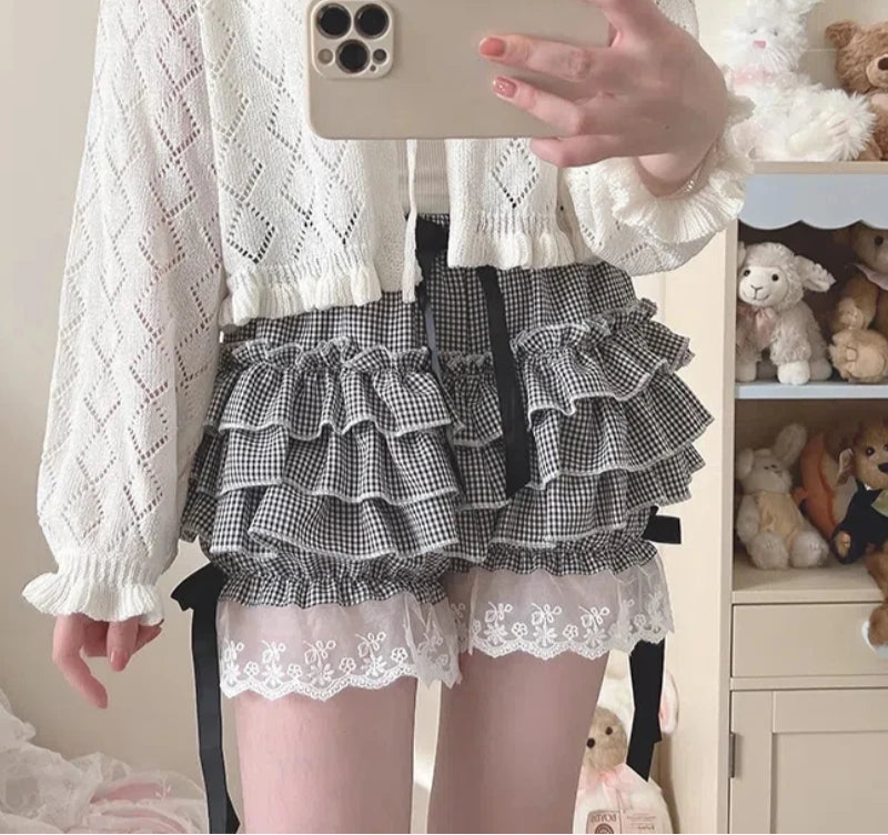 Person wearing a white lace top and plaid skirt with a phone in hand, surrounded by stuffed toys.