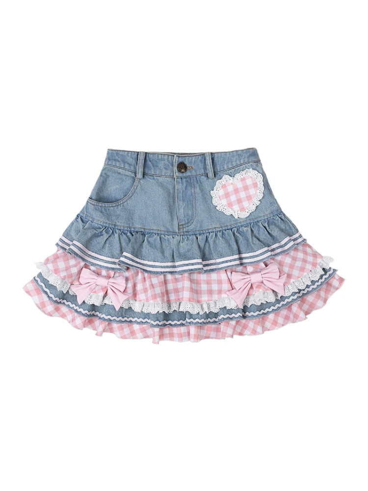 Denim skirt with pink gingham and bow details on a white background