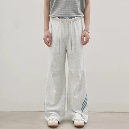 Pantalones deportivos casuales holgados con cordón elástico