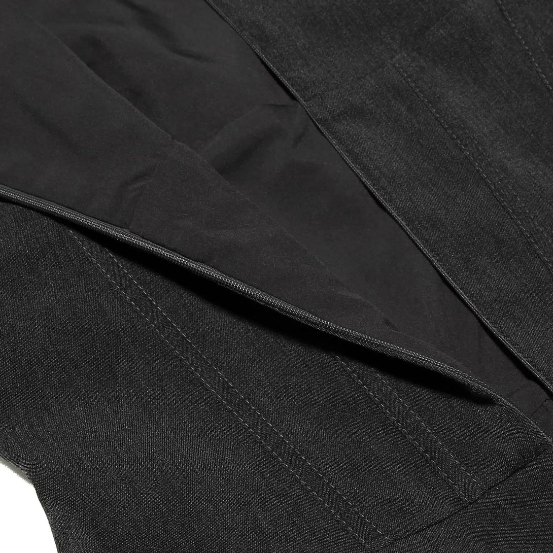 Close-up of a black Dress with a focus on the lapel and collar.