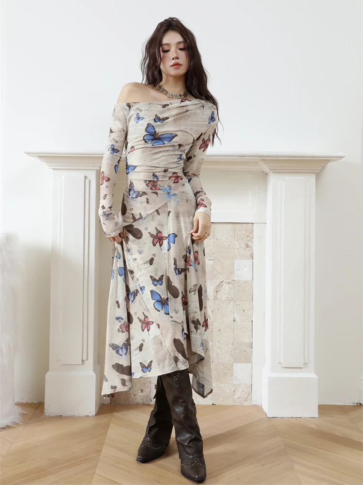 Woman wearing a butterfly-patterned dress in a minimalistic room.
