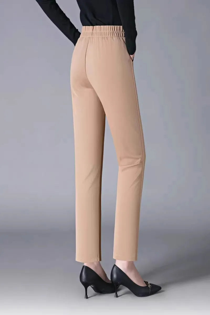 Beige pants worn by a person on a gray background
