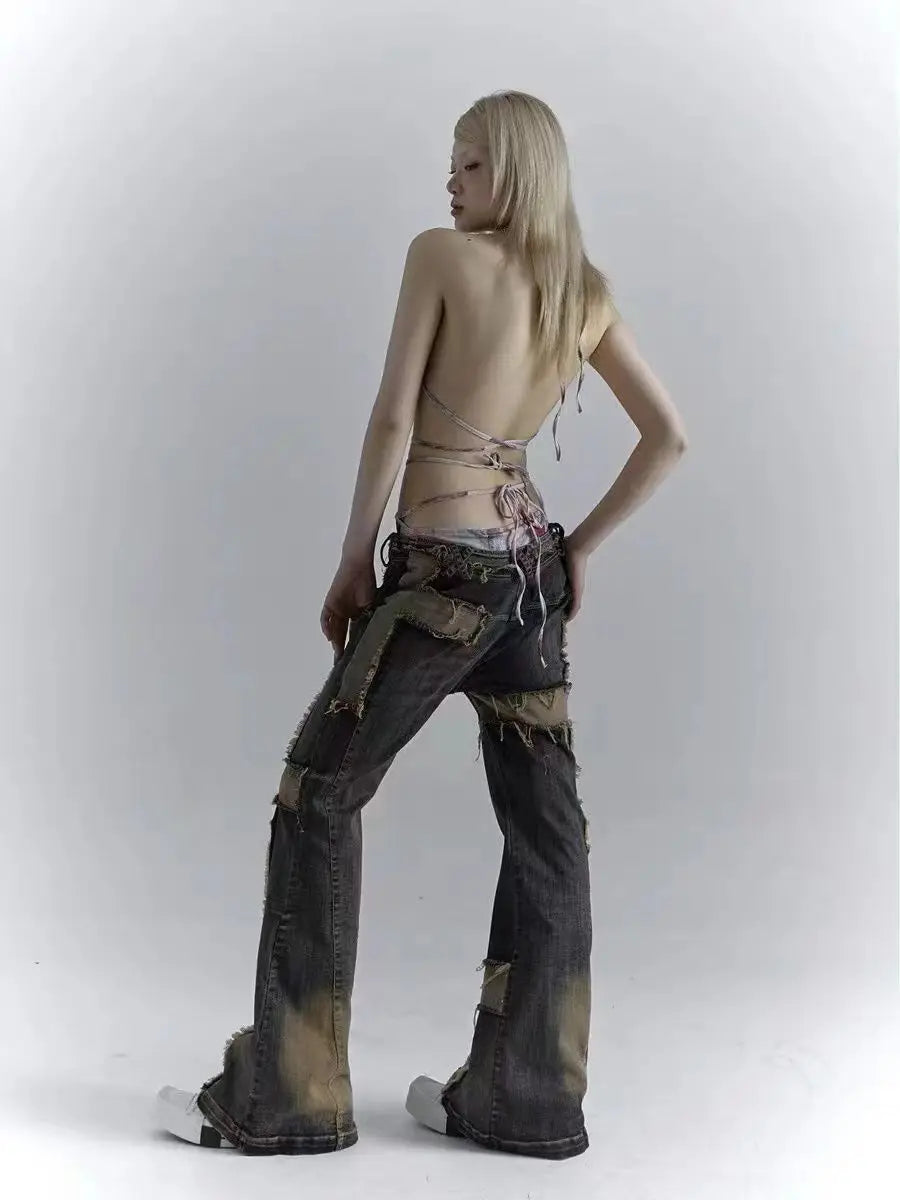 Model wearing the blue Distressed Patchwork Cross Jeans