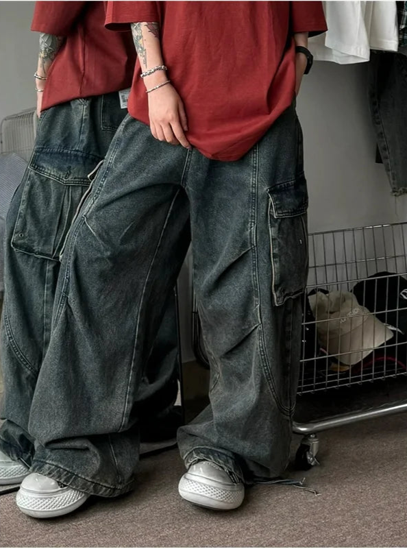 Person wearing a red shirt and blue cargo pants in an indoor setting.