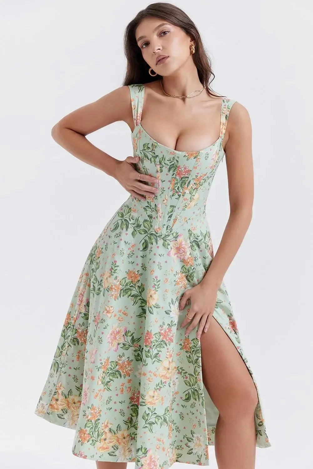 Woman wearing a floral dress with a slit on a white background