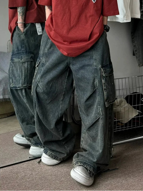 Person wearing oversized dark blue jeans and a red shirt in a casual setting.
